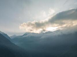 clouds over the mountains, mountains in the fog, during annapurna base camp, ghandruk, nepal photo
