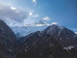 clouds over the mountains, mountains in the fog, during annapurna, annapurna base camp nepal photo