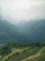 clouds over the mountains, mountains in the fog, during annapurna base camp, ghandruk, nepal photo