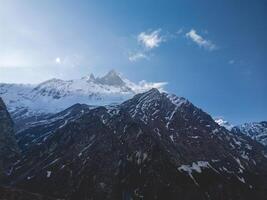 clouds over the mountains, mountains in the fog, during annapurna, annapurna base camp nepal photo