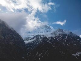 clouds over the mountains, mountains in the fog, during annapurna, annapurna base camp nepal photo