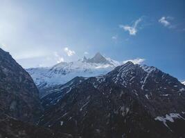 clouds over the mountains, mountains in the fog, during annapurna, annapurna base camp nepal photo