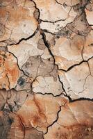 Top view photo of a solid color ground showing a large collapsed area from a strong impact, with cracks radiating outward