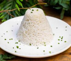 Tower of white rice of the basmati type as a garnish for meat photo
