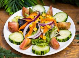 Very summery salad with cucumbers, onions, tomatoes and green sprouts photo