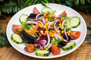 Very summery salad with cucumbers, onions, tomatoes and green sprouts photo