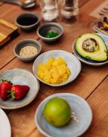 still life of avocado, peach and strawberries photo