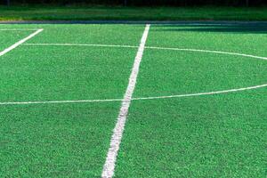 detail of the center line in a synthetic grass surface of a football field photo