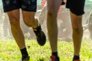 selective focus, athletes participating in obstacle course, OCR competition photo