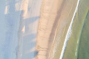 shore of a beach at sunrise in summer as seen from a drone, zenithal image photo