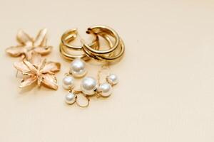 Gold ornaments from yellow metal on a light background. photo