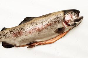Fish red river trout, cleaning the scales, home cooking photo
