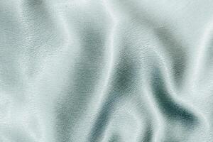 Blue shiny texture of silk satin satin with folds. photo