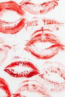 Imprint of red lips on white paper, kiss background photo