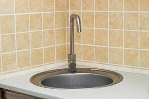 A sink with a faucet in the kitchen. photo