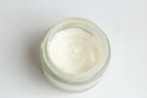Moisturizing spf cream in a jar on a light background. photo