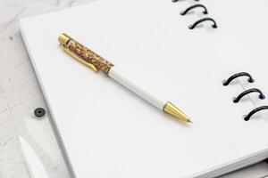 The pen lies in the notebook, the concept of study, time management. photo