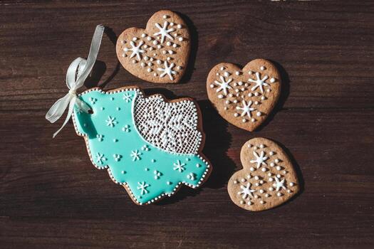 Homemade cookies in the shape of hearts and gingerbread in the shape of a Christmas tree with snowflakes photo