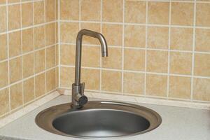 A sink with a faucet in the kitchen. photo