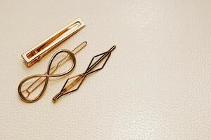 Gold ornaments from yellow metal on a light background. photo