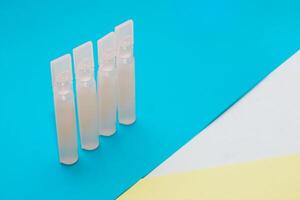 Probiotics medicine in vial on blue background. photo