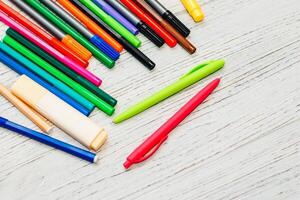 Stationery, colored felt-tip pens on a white table. photo