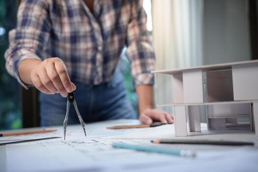 Architecture drawing on architectural project business architecture building construction Colleagues designer Planning Design on blueprint with compasses photo