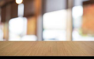 Mock up for space. Empty dark wooden table in front of abstract blurred bokeh background of restaurant . can be used for display or montage your product photo