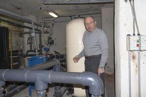 A room for dosing chemicals of chlorine and acid when feeding into the pool. Water circulation system in the pumping room. photo