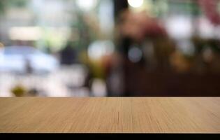 Empty wooden table in front of abstract blurred background of coffee shop . can be used for display or montage your products.Mock up for display of product photo