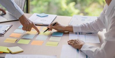 Business People brainstorming Meeting Design Ideas use post it notes to share idea professional investor start up project business brainstorming planning in office photo