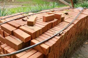 Pallet a red brick building material stack of new red bricks for construction. photo