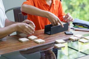 Asian father and son playing wood blocks game Carefree kid playing wood blocks game building constructor from blocks with father at home photo