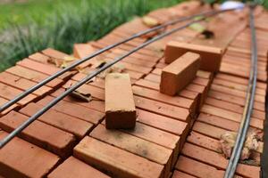 Pallet a red brick building material stack of new red bricks for construction. photo