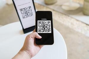 Qr code payment. E wallet. Man scanning tag accepted generate digital pay without money.scanning QR code online shopping cashless payment and verification technology concept. photo