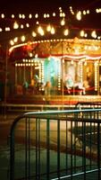 Illuminated Merry Go Round in Abandoned Amusement Park photo