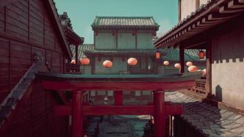 A red and green building with lanterns hanging from it's roof photo