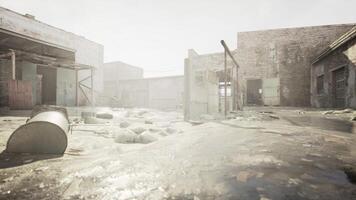 abandoned factory area with destroyed buildings and piles of garbage photo