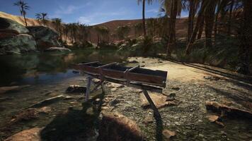 An old wooden Dredge in desert oasis photo