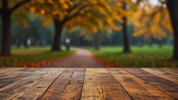 Empty wooden surface on blurred seasonal autumn background. Nature with view to park trees. Banner with copy space. Template showcase scene for display, montage, advertising product. photo