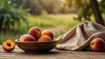 Ripe fragrant peaches in a bowl with tablecloth on a wooden surface on rustic countryside blurred background. Banner with copy space. Farm natural products concept. Nature landscape photo