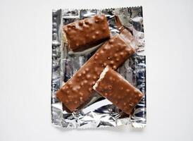 A sweet chocolate bar in a package. A waffle chocolate bar. photo