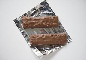 A sweet chocolate bar in a package. A waffle chocolate bar. photo
