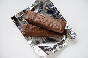 A sweet chocolate bar in a package. A waffle chocolate bar. photo