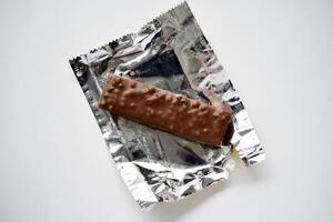 A sweet chocolate bar in a package. A waffle chocolate bar. photo