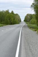 High-speed asphalt road in the spring forest. Country road. photo