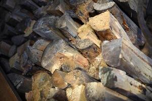 There's firewood in the closet. Stacked firewood. Storage of firewood. photo