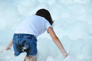 happy girl with foam on her head, in wet clothes at a foam party, in wet clothes at a foam party photo
