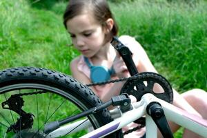 Young girl cyclist enjoy the beautiful sunrise on summer forest trail photo