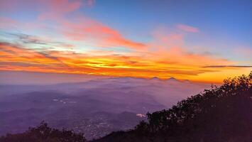 morning sunrise light at the top of Mount Slamet with a background of colorful sky light patterns photo